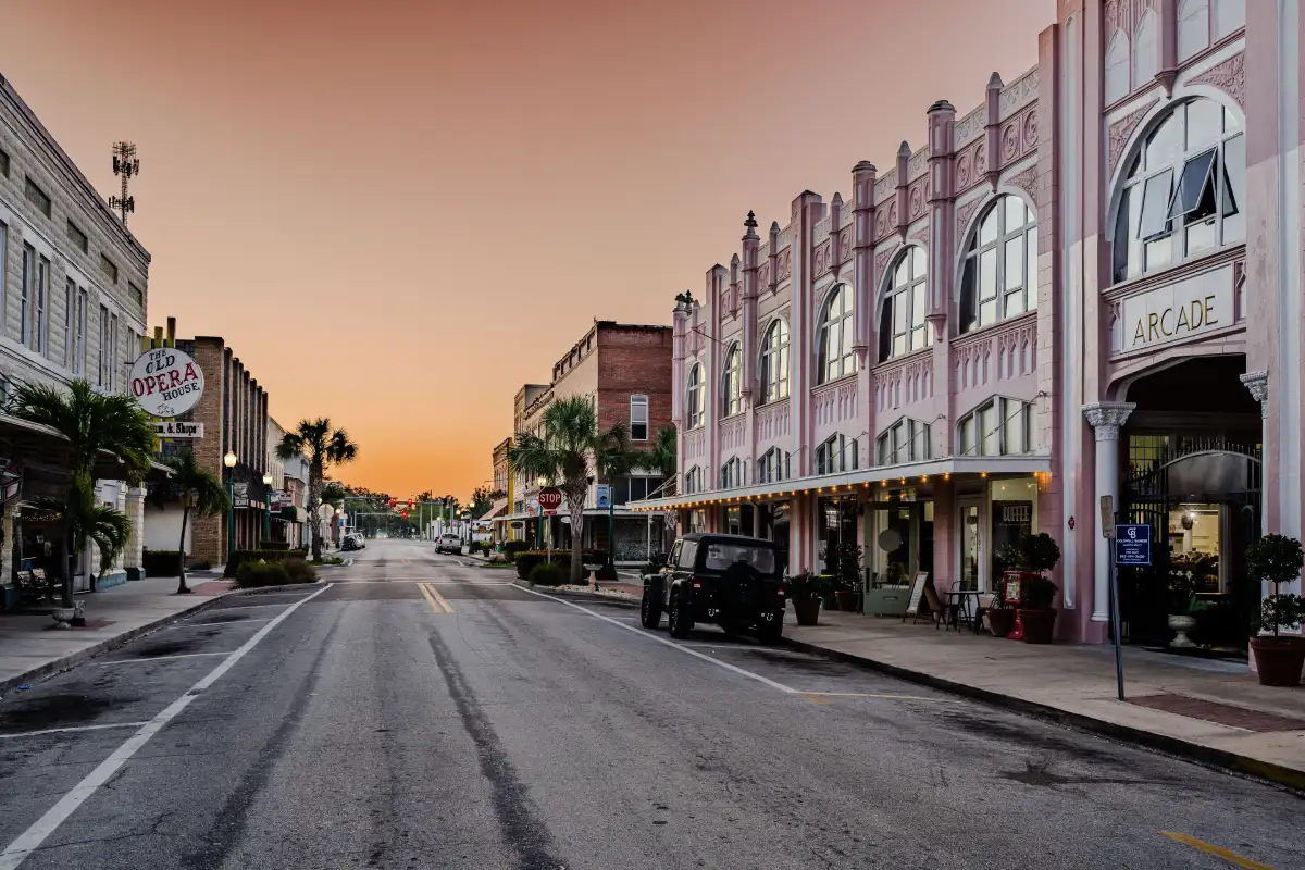 Empty urban street with historic commercial buildings during sunset in a peaceful downtown area